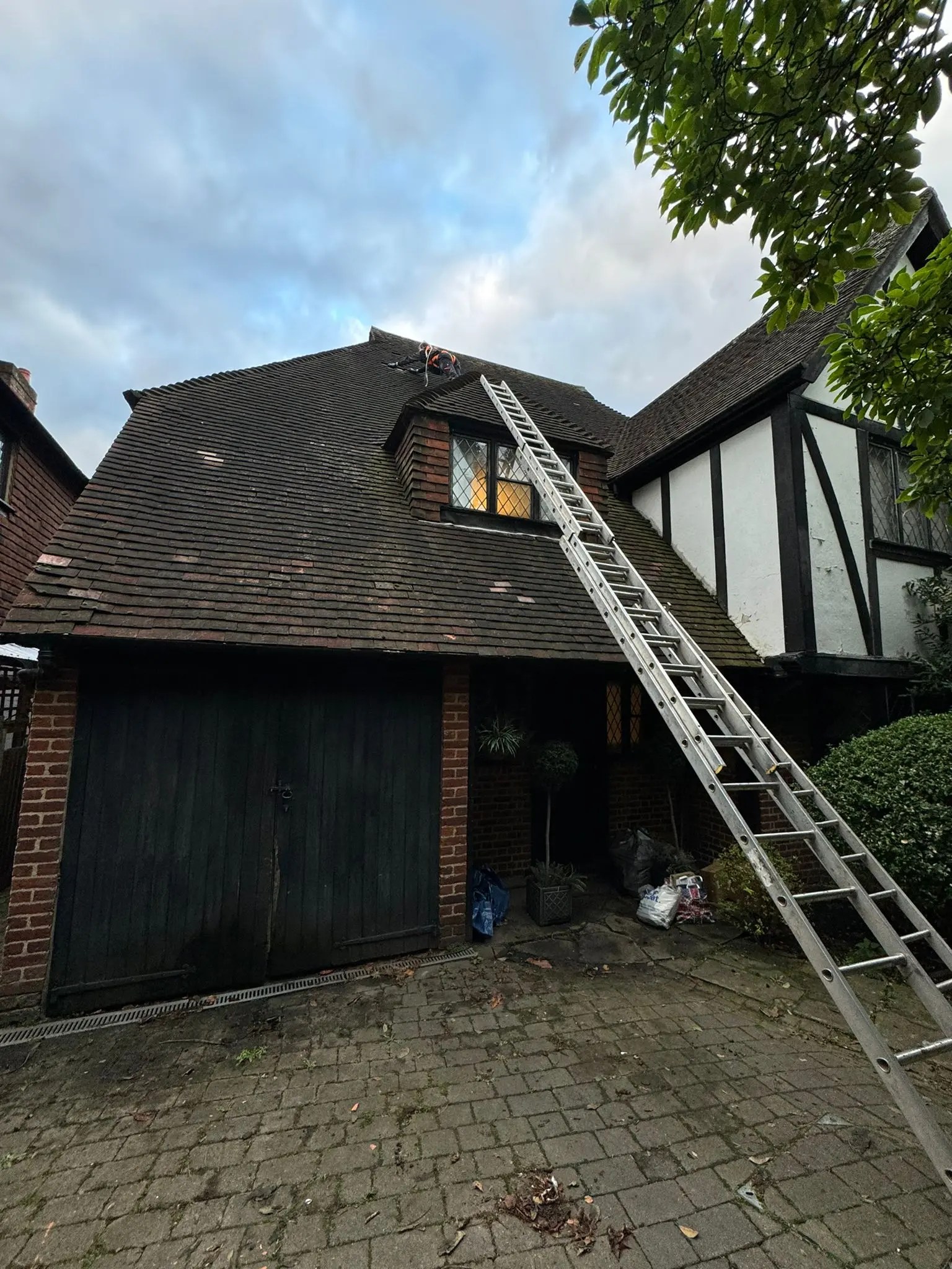 Diamond Gutters UK dark, stained roof in need of professional cleaning to remove dirt
