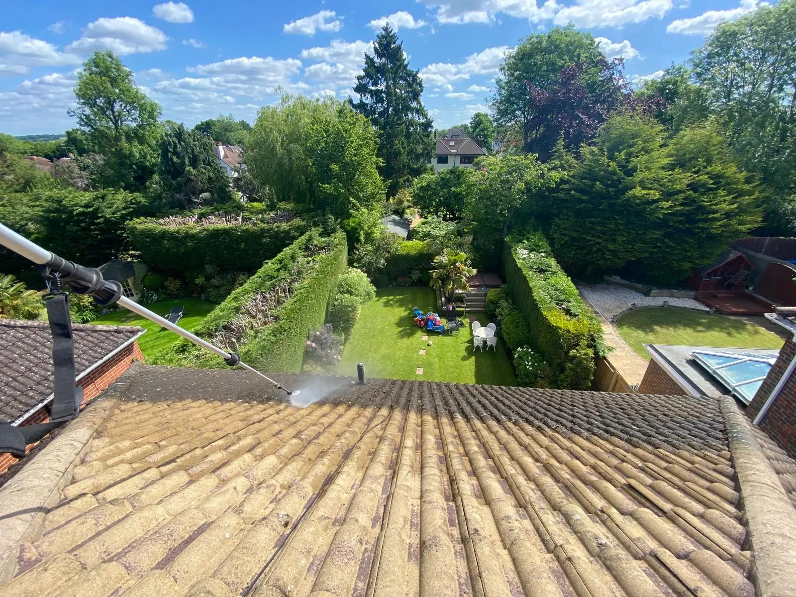 Diamond Gutters UK roof cleaning before and after on a house with grey tiles